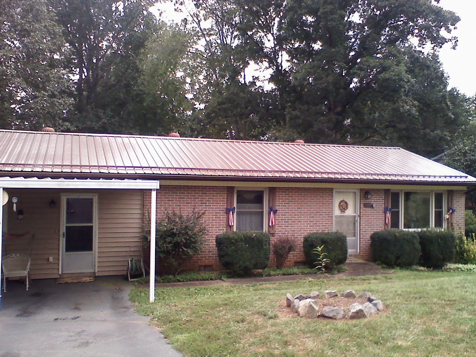 Bronze metal roof and carport on a brick ranch home — Roof Repair work by our crew in Ridgefield